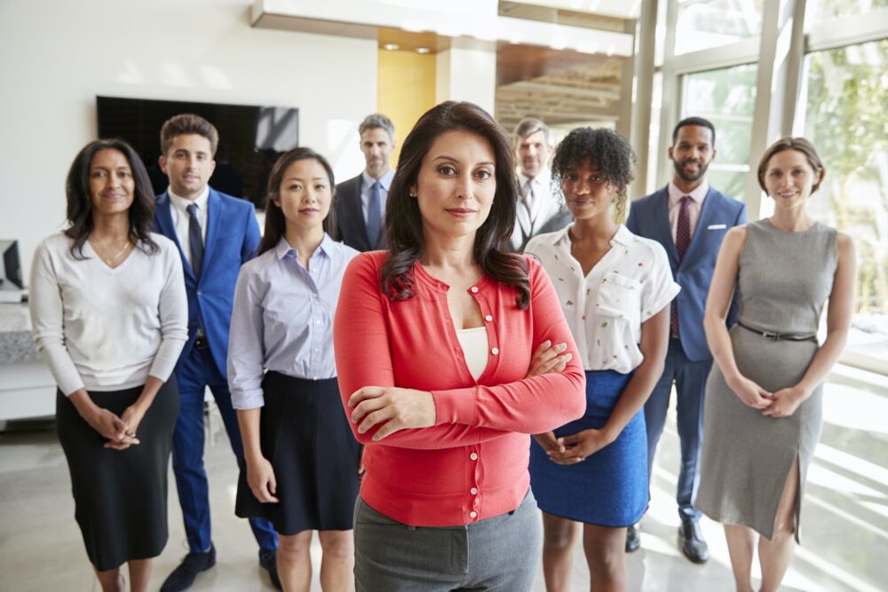 Hispanic businesswoman and her business team, group portrait